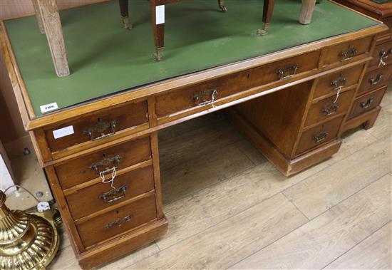 A late Victorian golden oak pedestal desk, W.135cm H.74cm D.74cm